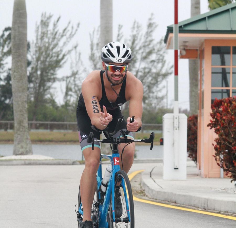 Philip waving at the camera while biking at CCNC Nationals in Miami, FL